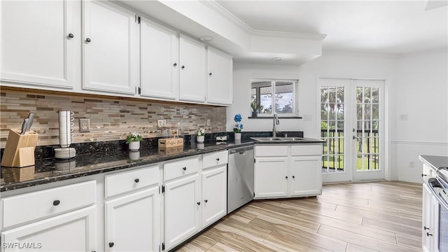 2920 24th Ave SE, Naples, FL 34117 - kitchen featuring white cabinets, decorative backsplash, stainless steel appliances, and a sink