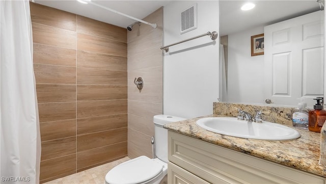 2920 24th Ave SE, Naples, FL 34117 - bathroom with tiled shower, toilet, visible vents, recessed lighting, and vanity