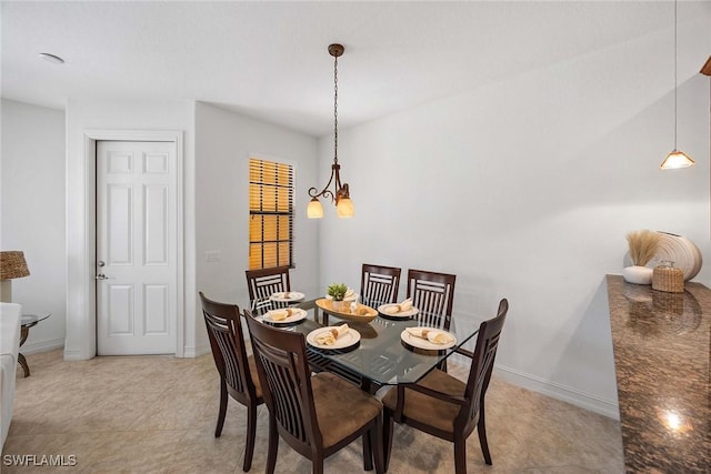 9134 Chula Vista St Unit 125, Naples, FL 34113 - dining room featuring light tile patterned floors, baseboards, and a notable chandelier