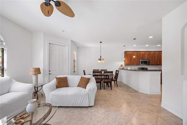 9134 Chula Vista St Unit 125, Naples, FL 34113 - living room featuring light tile patterned floors, recessed lighting, and ceiling fan with notable chandelier