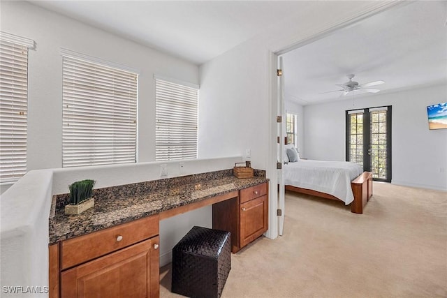 9134 Chula Vista St Unit 125, Naples, FL 34113 - bedroom featuring built in study area, ceiling fan, and light carpet