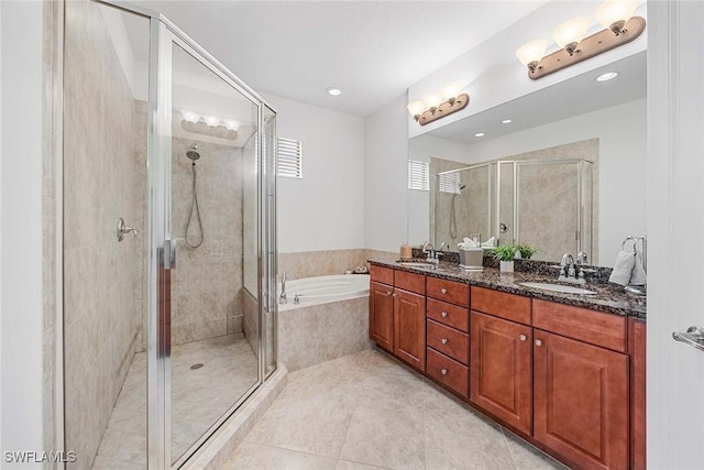 9134 Chula Vista St Unit 125, Naples, FL 34113 - full bathroom featuring a sink, a bath, a shower stall, and double vanity