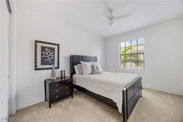 9134 Chula Vista St Unit 125, Naples, FL 34113 - bedroom with baseboards, ceiling fan, and light colored carpet