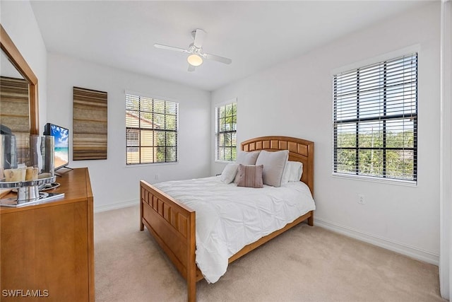 9134 Chula Vista St Unit 125, Naples, FL 34113 - bedroom with ceiling fan, light colored carpet, and baseboards