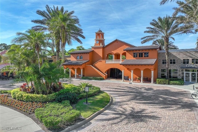 9134 Chula Vista St Unit 125, Naples, FL 34113 - mediterranean / spanish home with a tile roof, stucco siding, and curved driveway