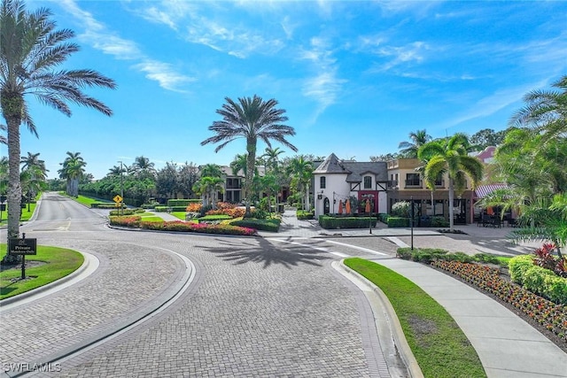 9134 Chula Vista St Unit 125, Naples, FL 34113 - view of road featuring traffic signs, sidewalks, and curbs