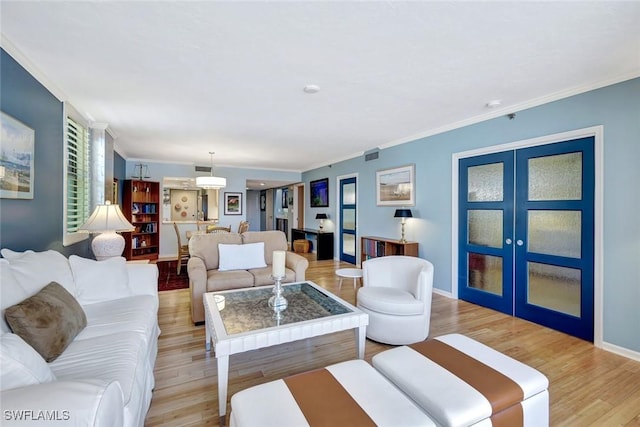 3100 Gulf Shore Blvd N Unit 103, Naples, FL 34103 - living room featuring light wood-type flooring, ornamental molding, french doors, and baseboards
