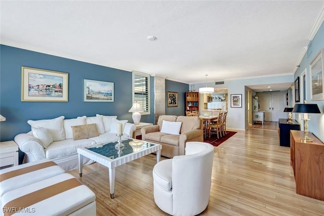 3100 Gulf Shore Blvd N Unit 103, Naples, FL 34103 - living room featuring ornamental molding, light wood-type flooring, and baseboards