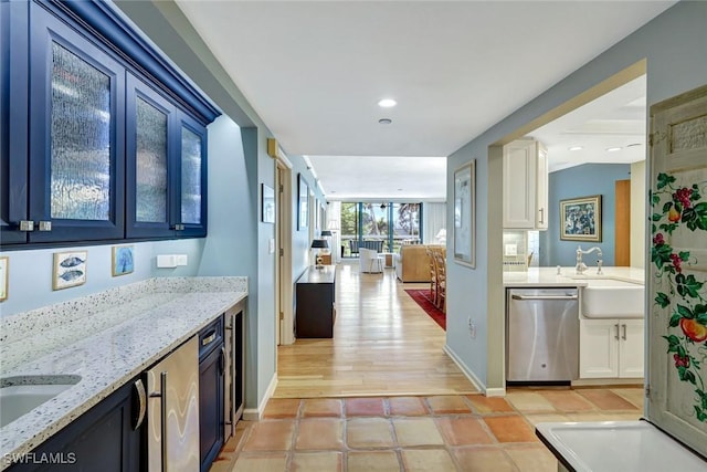 3100 Gulf Shore Blvd N Unit 103, Naples, FL 34103 - kitchen featuring dishwasher, a sink, white cabinetry, light stone countertops, and recessed lighting