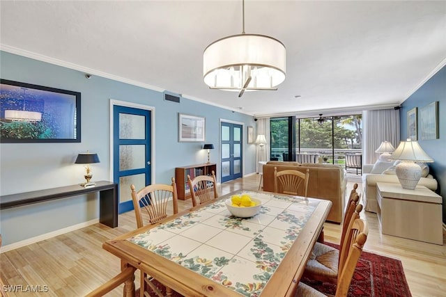 3100 Gulf Shore Blvd N Unit 103, Naples, FL 34103 - dining space featuring ornamental molding, light wood-style floors, and baseboards