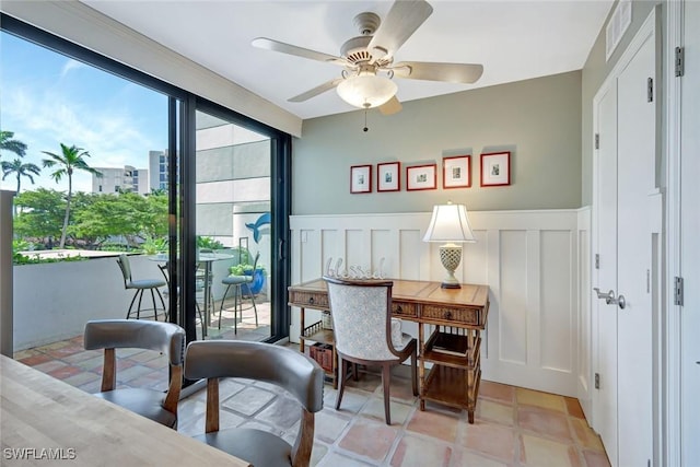 3100 Gulf Shore Blvd N Unit 103, Naples, FL 34103 - dining space featuring ceiling fan, wainscoting, and a decorative wall