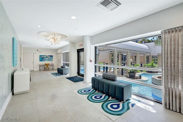 3100 Gulf Shore Blvd N Unit 103, Naples, FL 34103 - living room featuring a chandelier, recessed lighting, and tile patterned flooring