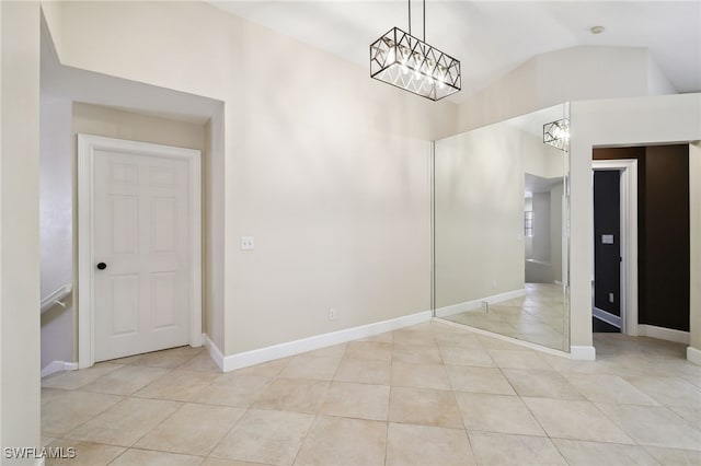 3770 Fieldstone Blvd Unit 1508, Naples, FL 34109 - tiled empty room featuring lofted ceiling, a chandelier, and baseboards