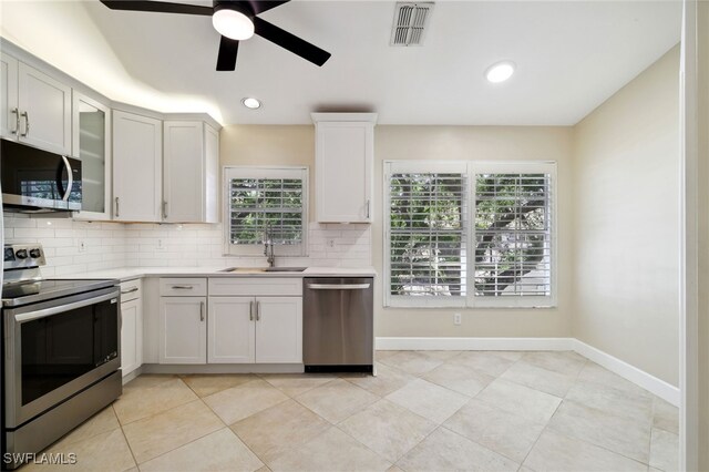 3770 Fieldstone Blvd Unit 1508, Naples, FL 34109 - kitchen with a sink, decorative backsplash, ceiling fan, appliances with stainless steel finishes, and visible vents