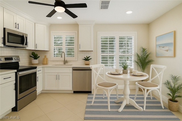 3770 Fieldstone Blvd Unit 1508, Naples, FL 34109 - kitchen with a sink, tasteful backsplash, a ceiling fan, light countertops, and appliances with stainless steel finishes