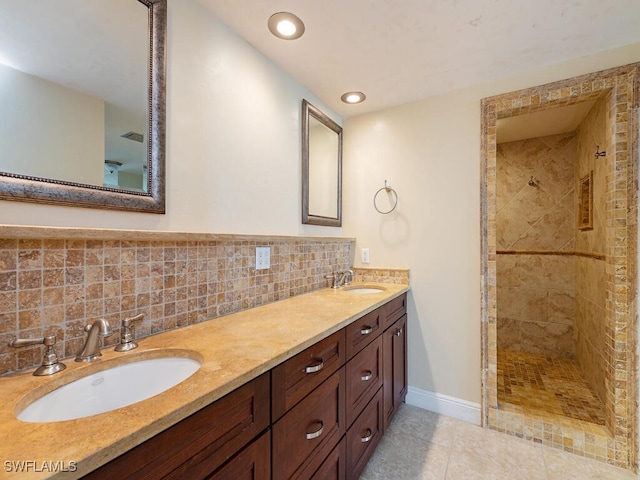full bathroom featuring a sink, double vanity, and a tile shower