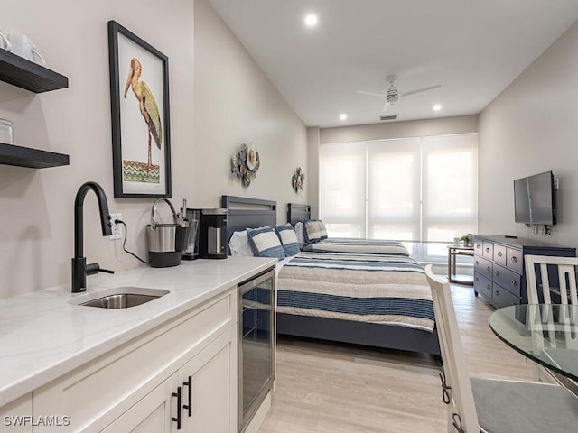 bedroom featuring a sink, light wood-style floors, wine cooler, visible vents, and recessed lighting