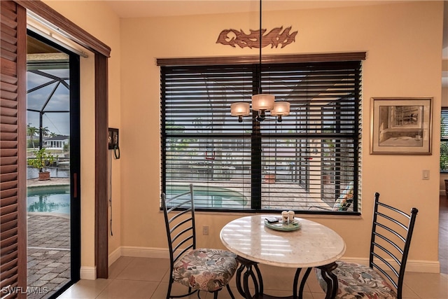 tiled dining space featuring baseboards