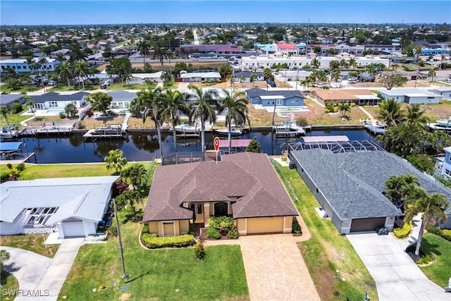 birds eye view of property with a water view and a residential view