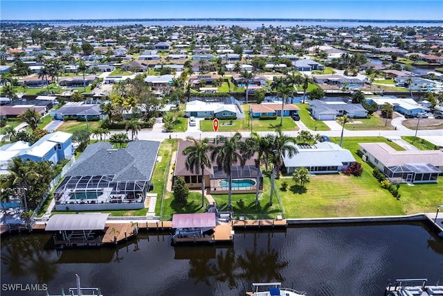 bird's eye view featuring a water view and a residential view