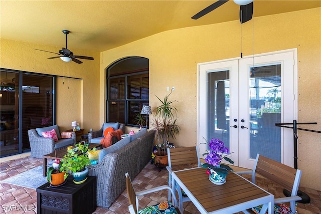 view of patio with an outdoor living space, a ceiling fan, outdoor dining area, and french doors