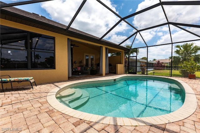 pool featuring a patio and glass enclosure