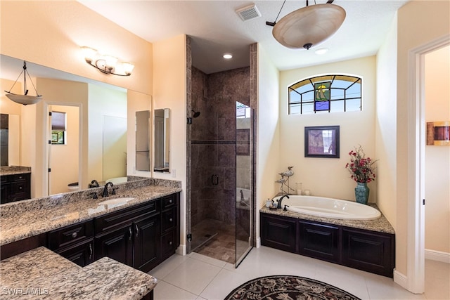 bathroom featuring tile patterned floors, a shower stall, a bath, and vanity