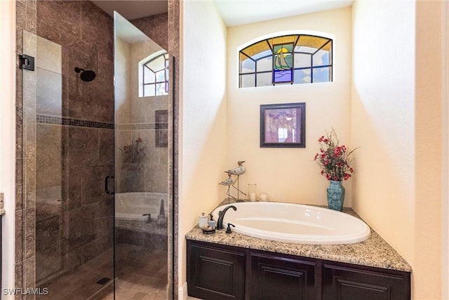 bathroom with a stall shower and a bath