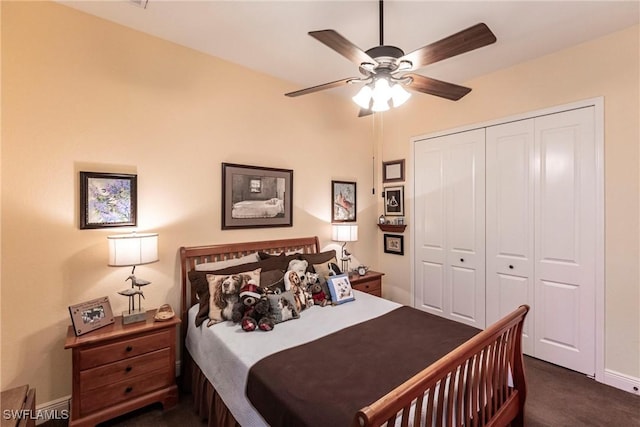 bedroom featuring a closet, ceiling fan, dark colored carpet, and baseboards