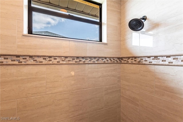 bathroom with a tile shower