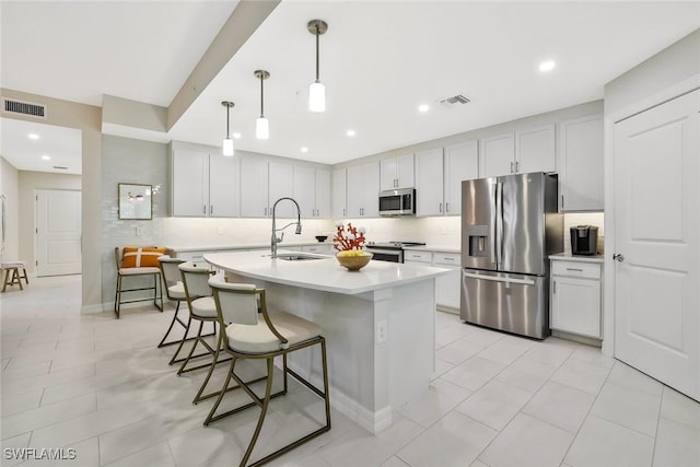 190 Indies Dr E Unit 102, Naples, FL 34114 - kitchen with a sink, visible vents, tasteful backsplash, and appliances with stainless steel finishes