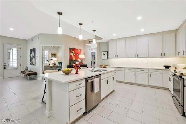 190 Indies Dr E Unit 102, Naples, FL 34114 - kitchen featuring appliances with stainless steel finishes, a kitchen island with sink, light countertops, a sink, and decorative backsplash