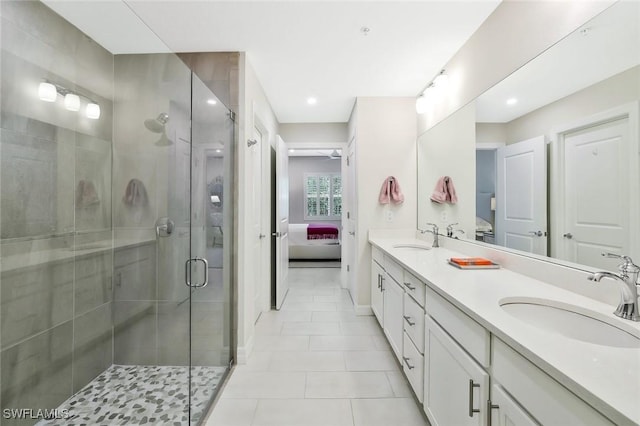190 Indies Dr E Unit 102, Naples, FL 34114 - ensuite bathroom featuring tile patterned flooring, double vanity, a sink, and connected bathroom