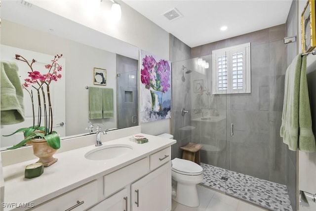 190 Indies Dr E Unit 102, Naples, FL 34114 - full bath with visible vents, toilet, a shower stall, vanity, and tile patterned floors