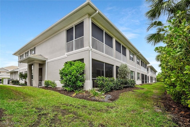 190 Indies Dr E Unit 102, Naples, FL 34114 - view of home's exterior featuring stucco siding and a lawn