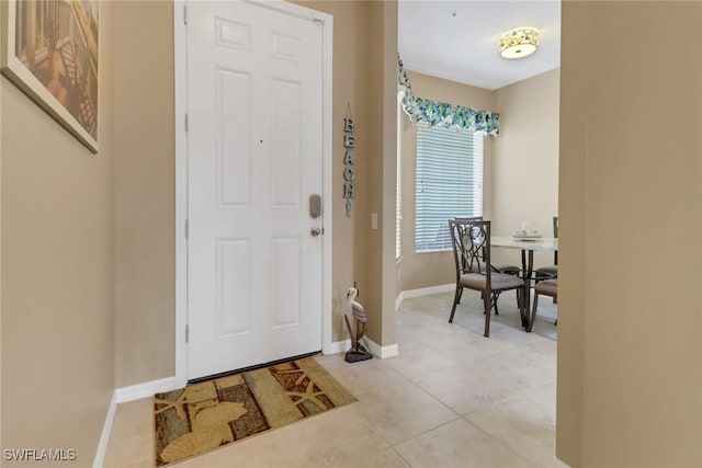 entrance foyer featuring baseboards and light tile patterned floors