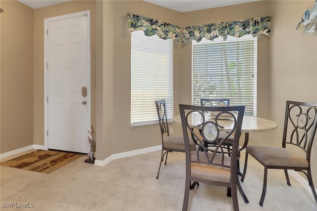 dining room featuring plenty of natural light and baseboards