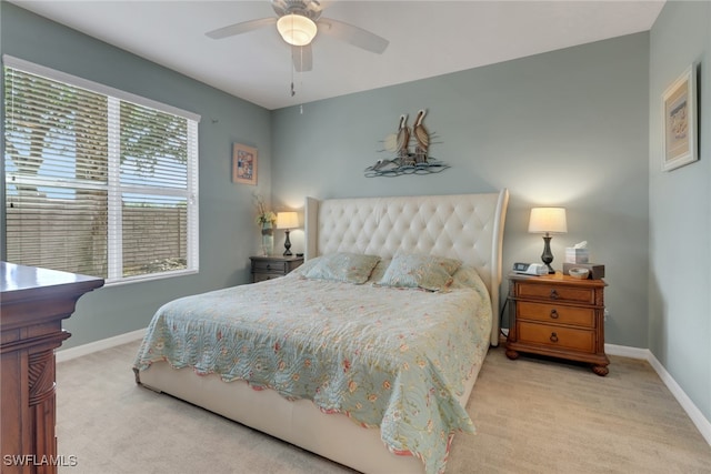 carpeted bedroom with baseboards and a ceiling fan
