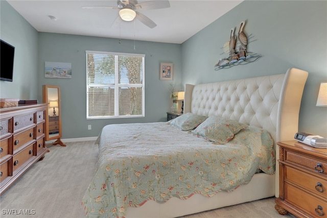 bedroom featuring a ceiling fan, baseboards, and light carpet