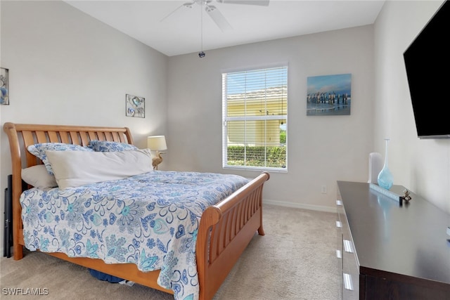 carpeted bedroom featuring baseboards and ceiling fan