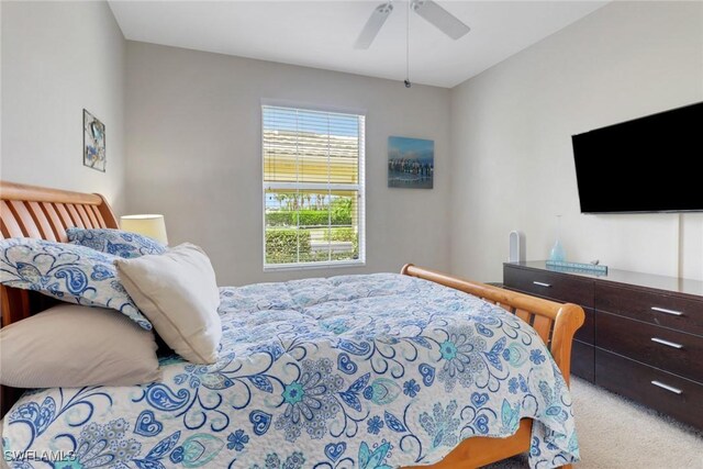 bedroom with a ceiling fan and carpet flooring