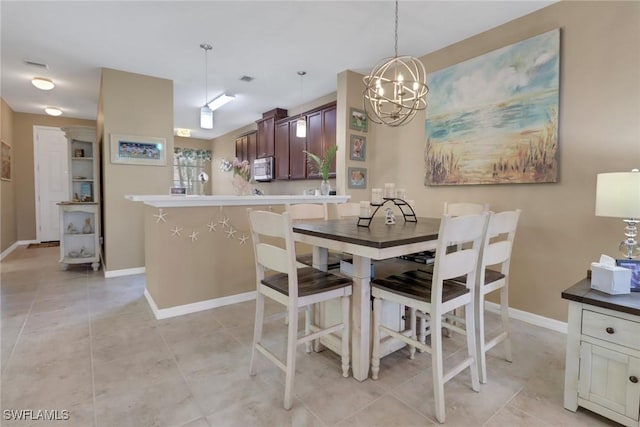 dining room featuring baseboards, a chandelier, and light tile patterned flooring