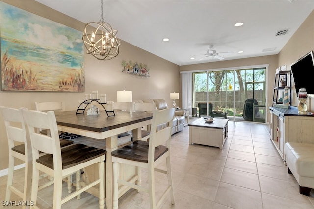 dining area featuring light tile patterned flooring, ceiling fan with notable chandelier, visible vents, and recessed lighting