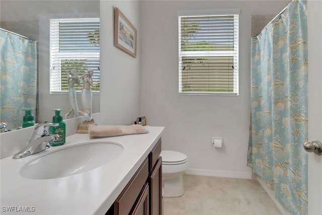 full bath featuring toilet, vanity, and baseboards