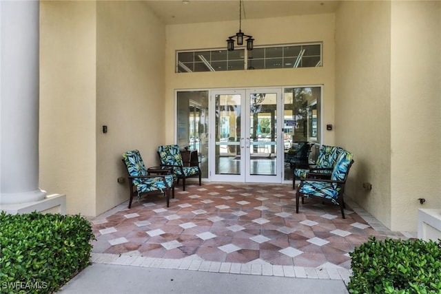 view of exterior entry with french doors and stucco siding