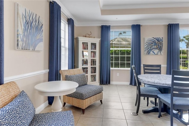 sitting room with baseboards, crown molding, and tile patterned floors