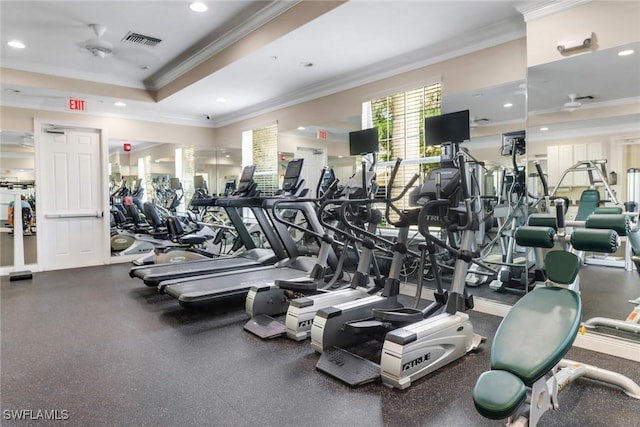 gym with recessed lighting, crown molding, visible vents, and a raised ceiling