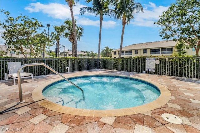 view of swimming pool featuring fence