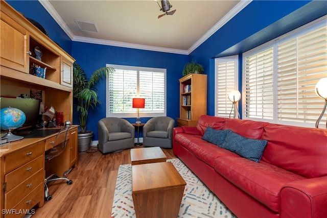 living area featuring visible vents, ornamental molding, and light wood-style floors