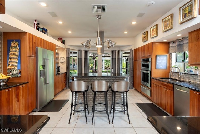 kitchen featuring stainless steel appliances, a sink, a warming drawer, and modern cabinets